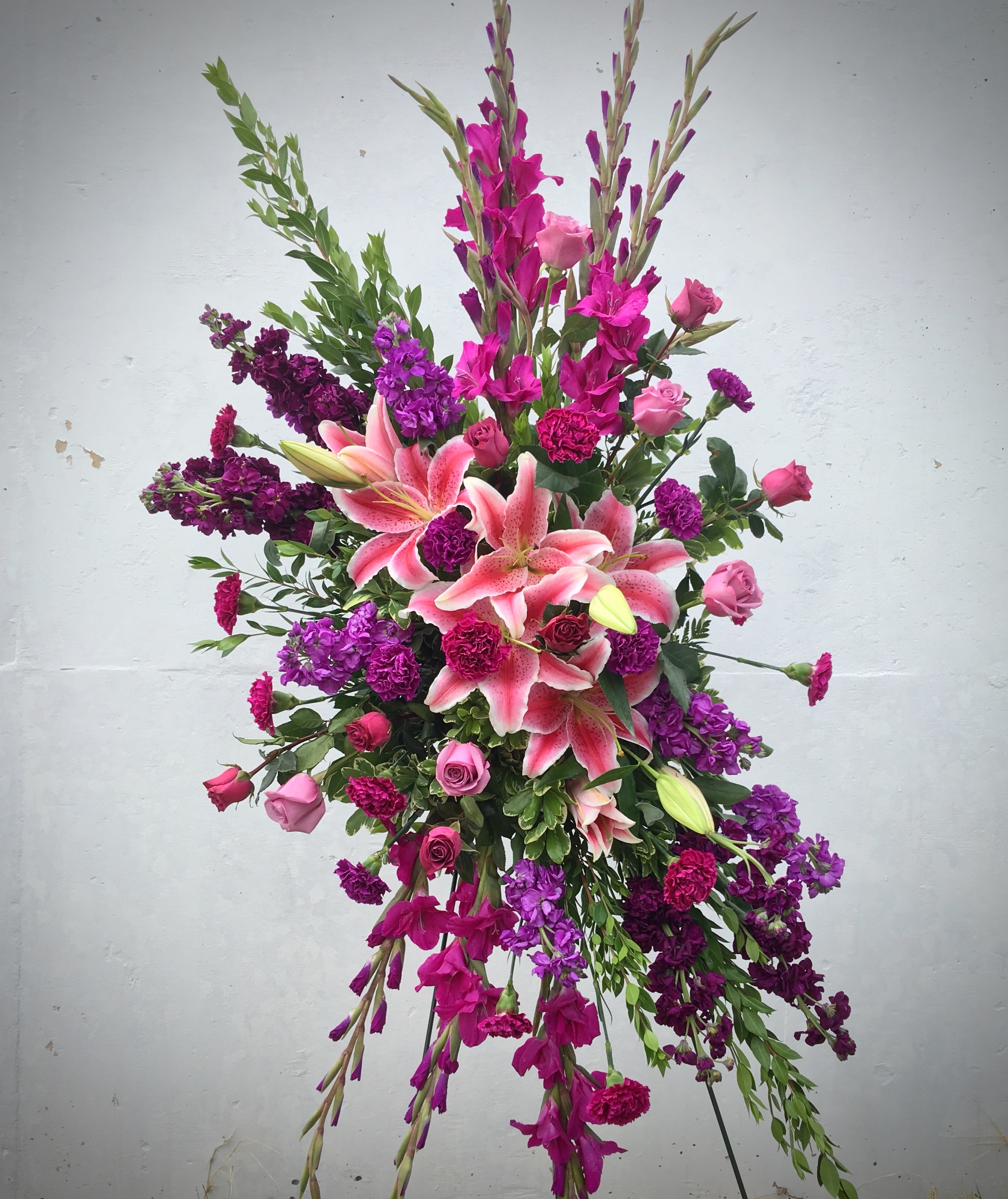 Tall floral spray with pink lilies and purple blooms