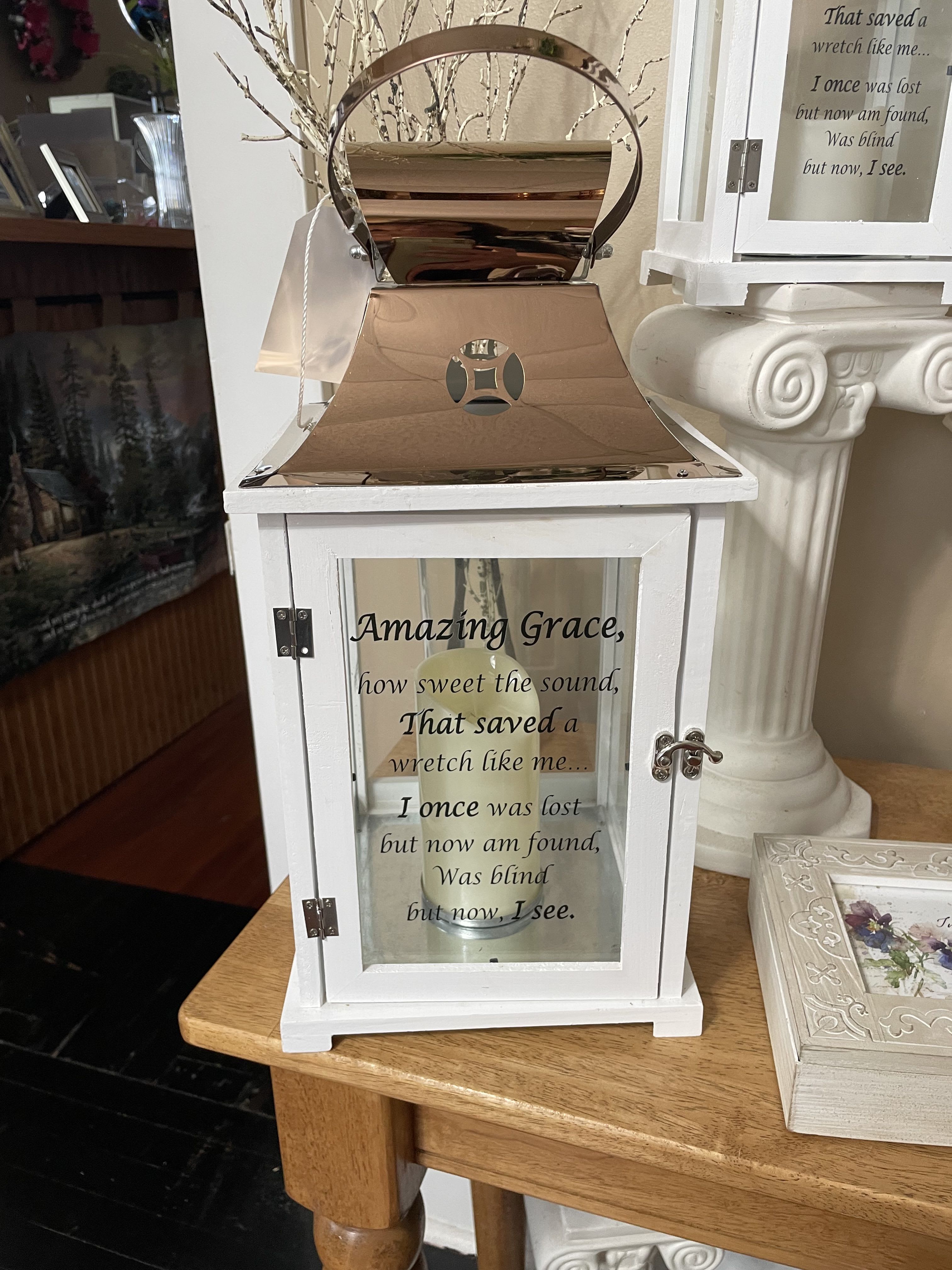White lantern with "Amazing Grace" text and a candle inside