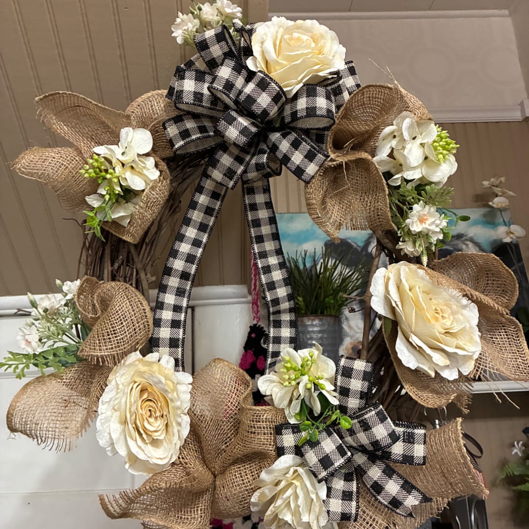 Cream rose wreath with burlap bows and black-and-white ribbon