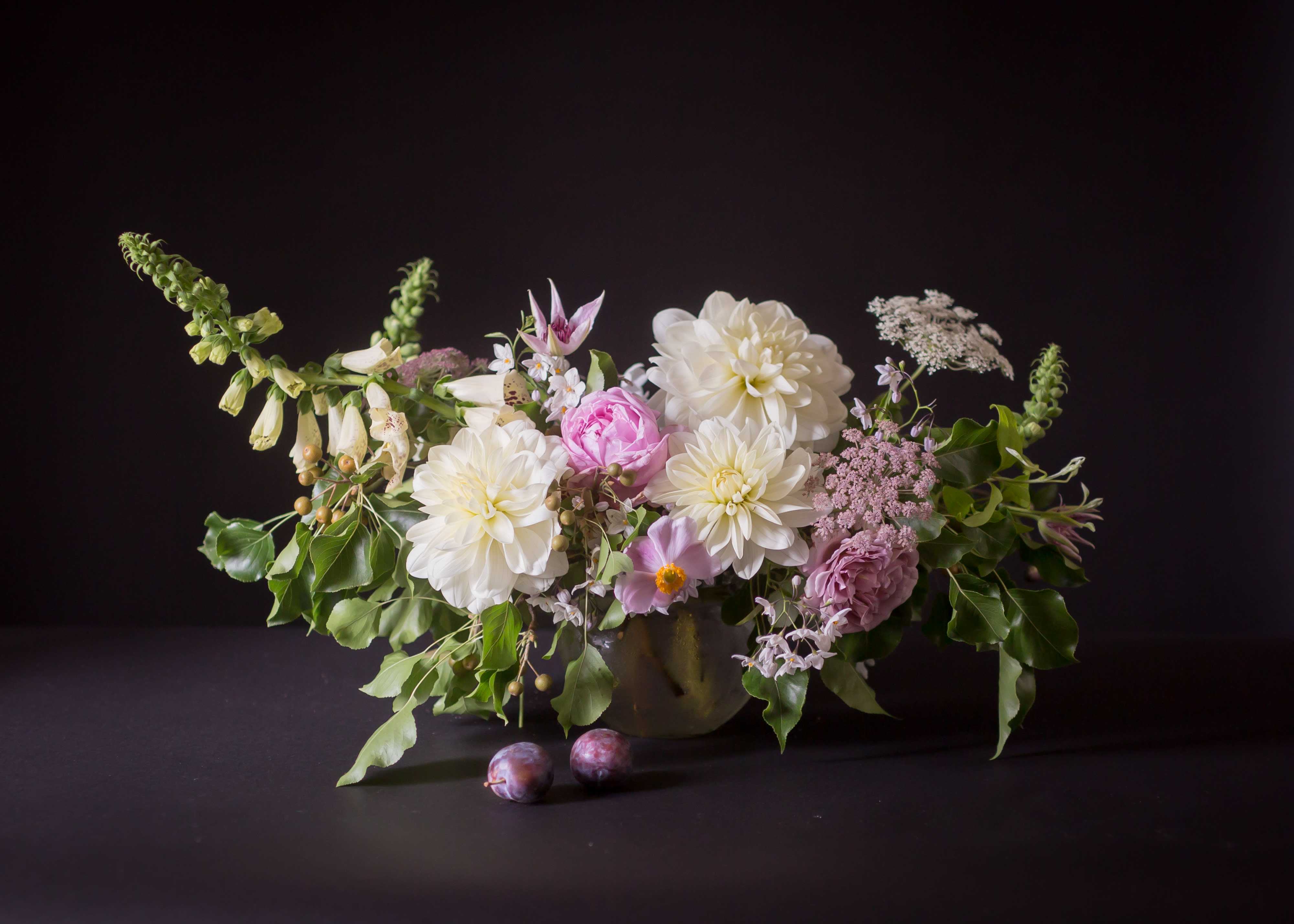 Low floral arrangement with white and pink blooms in a vase