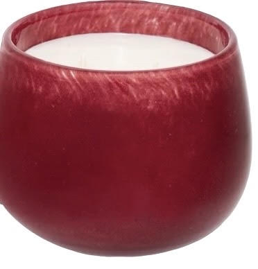 Red glass candle holder with a white candle inside