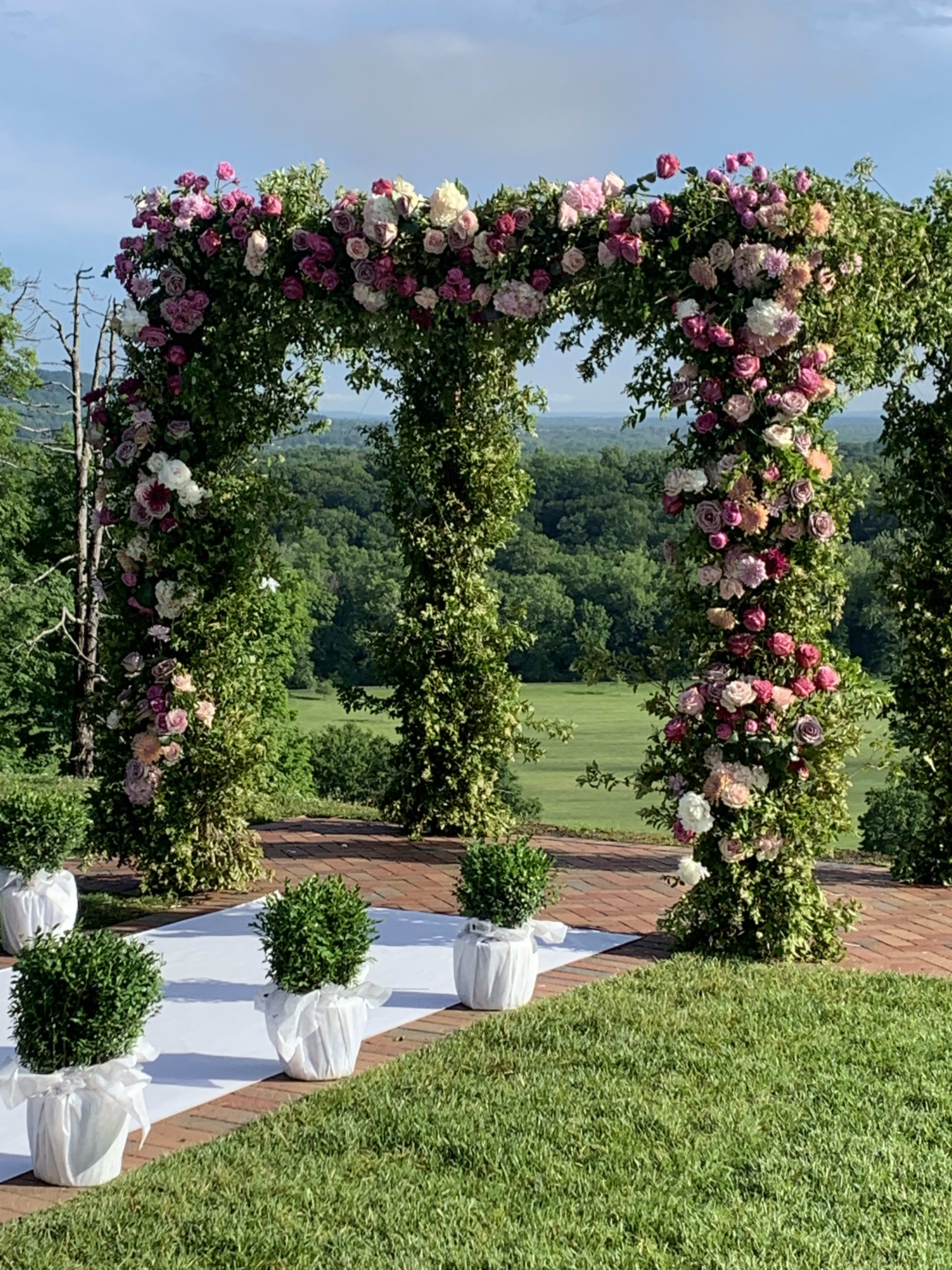 Happy Happy Chuppah - Happy Happy Chuppah Is a spectacular, on trend design style for today’s wedding ceremony. Covered in greens and abundant premium blooms. Includes local delivery, installation and breakdown. 