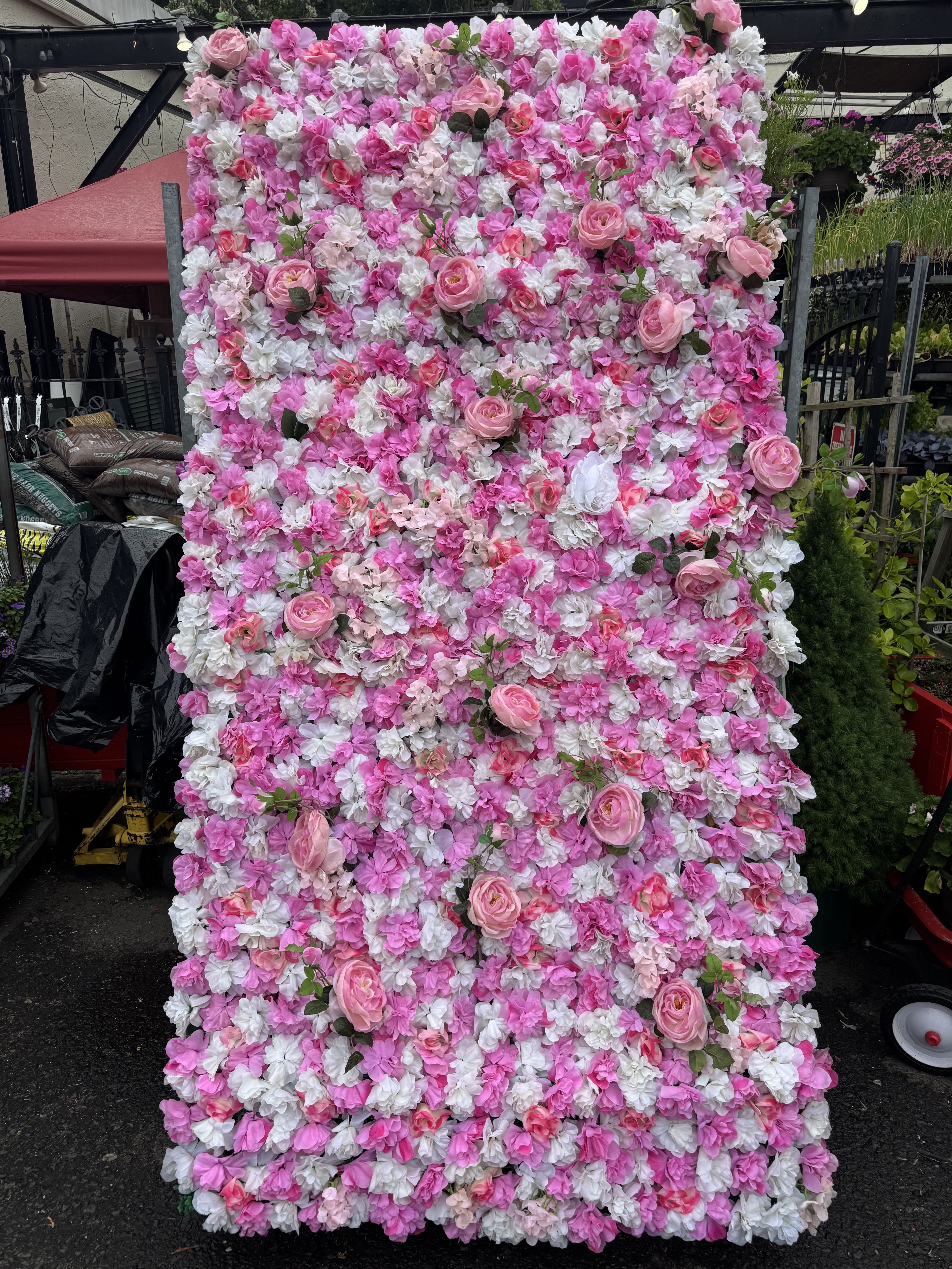 Pink and white floral wall with scattered roses