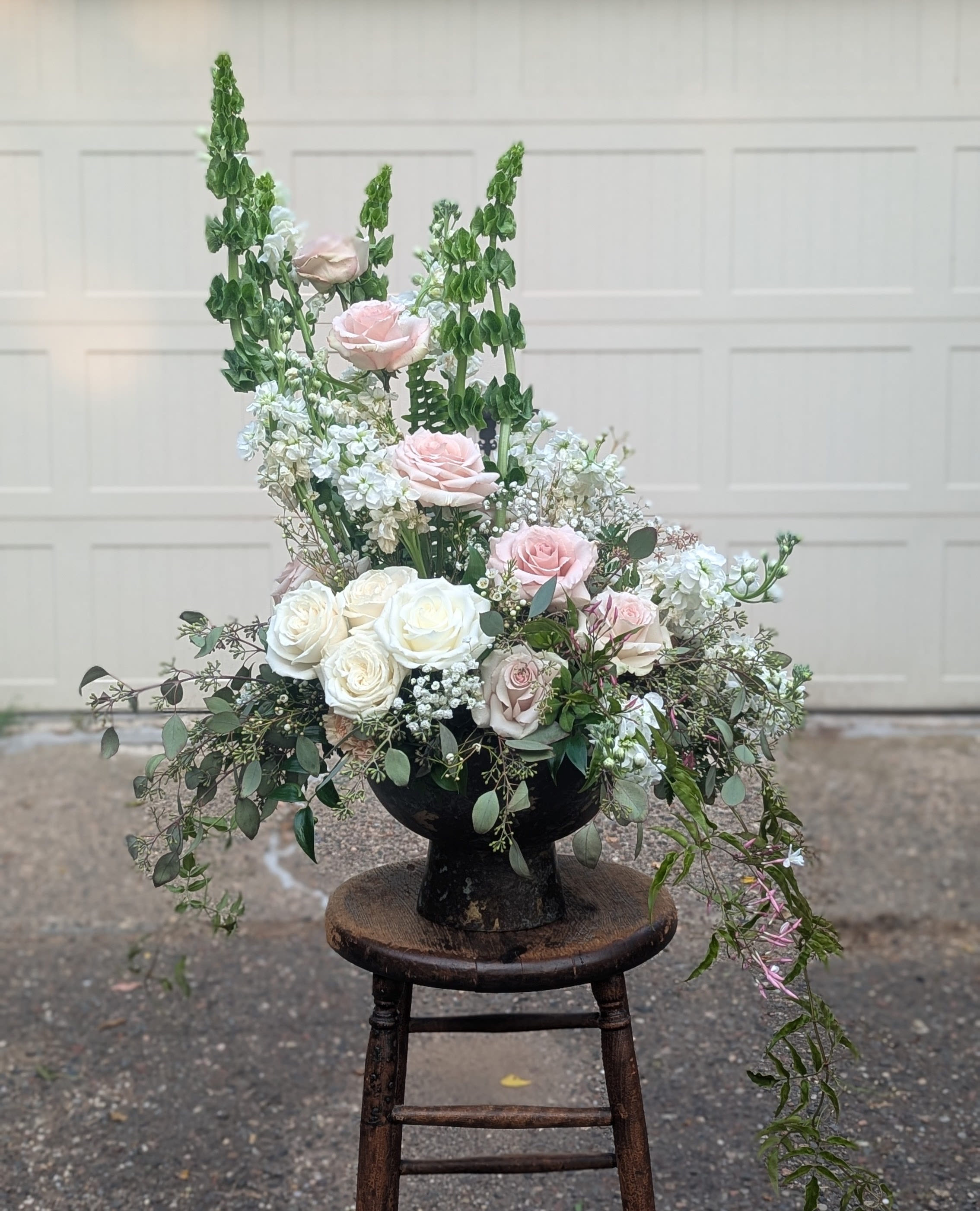 Garden of Thanks - Romantic garden-style arrangement in a keepsake container. Abundant roses and lush overflowing accents.  Subject to seasonal availability, substitutions, if needed, maintain the same shape and style. 