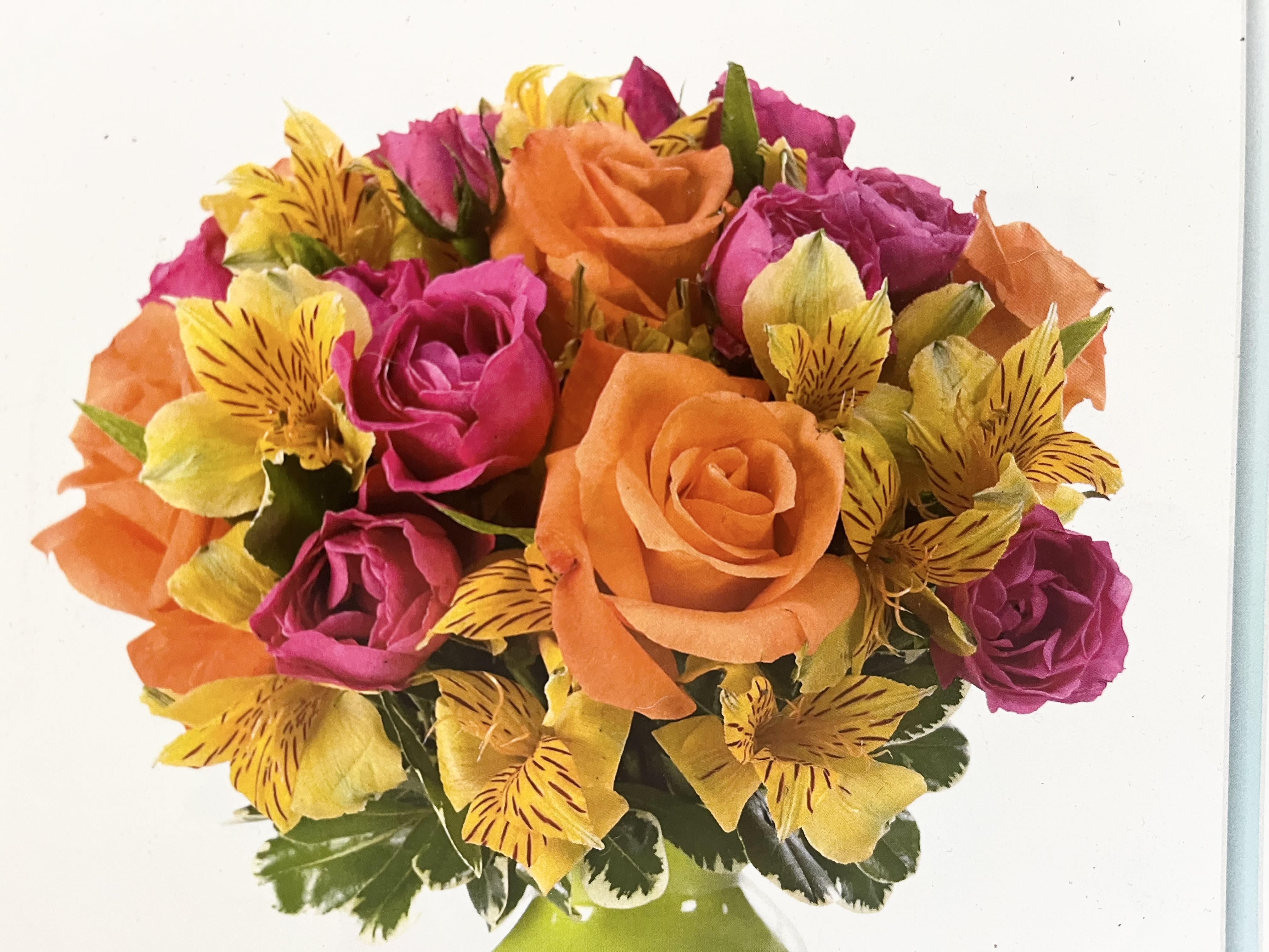 Bouquet of orange and pink roses with yellow striped flowers