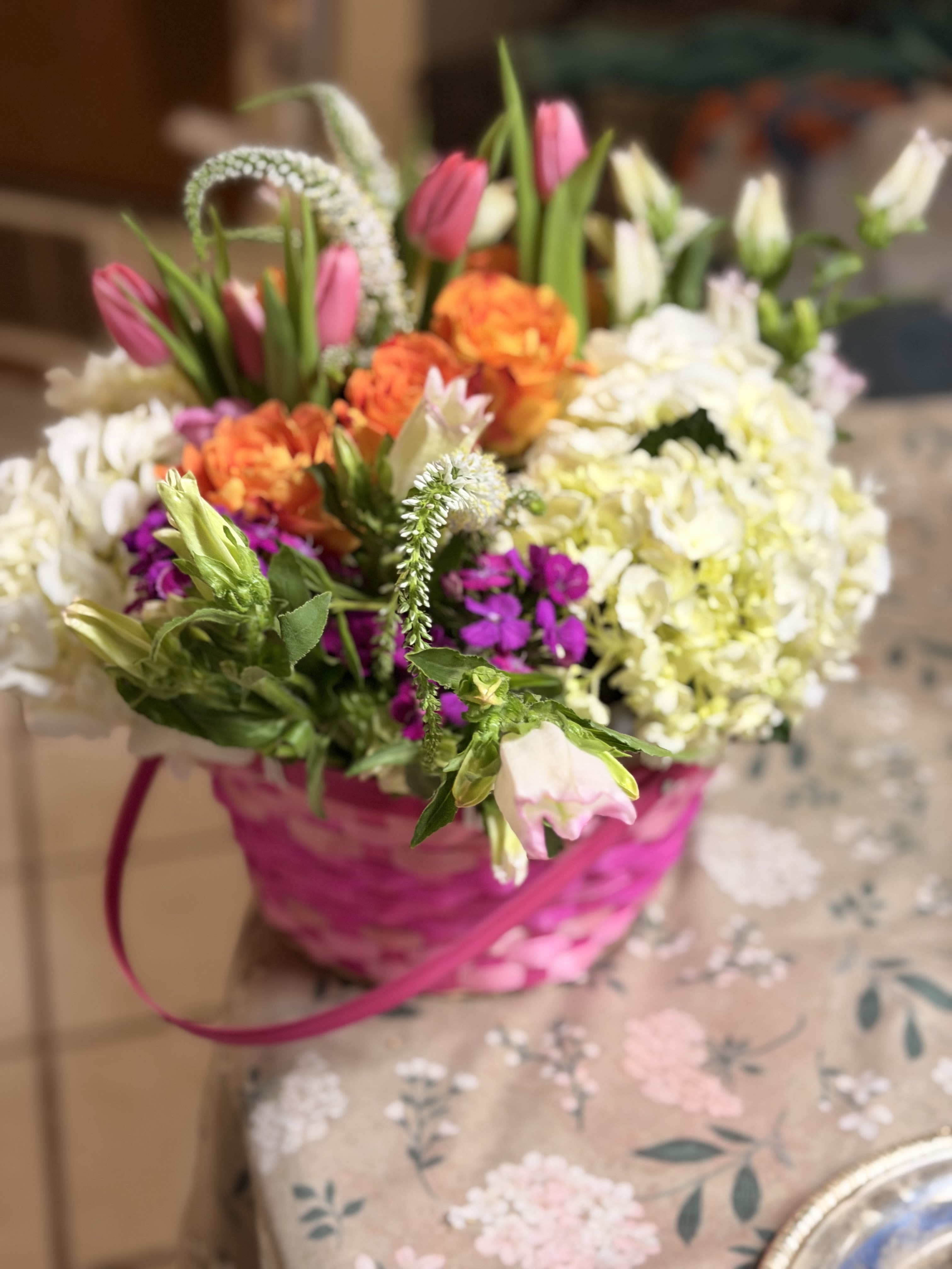  The Garden Party Glow - This blooming basket is filled to the brim with a variety of our Spring Collection. Roses, hydrangeas, tulips and more!! Oh my!!