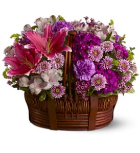 Basket of Bliss [TFWEB373] - For a fabulous gift for a birthday, anniversary or any special occasion, send a woven basket overflowing with blossoms in pretty shades of pink, lavender and burgundy. With blooms as beautiful as this, they're bound to feel a sense of absolute bliss!  A mix of fresh pink, lavender and burgundy flowers such as Asiatic lilies, Sweet William, button spray chrysanthemums and waxflower – accented with greenery – is delivered in a woven basket.  Approximately 17.5" (W) x 15" (H)  Orientation: All-Around      As Shown : TFWEB373  