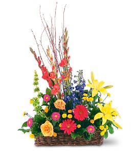 Colorful mixed flower arrangement in a wicker basket