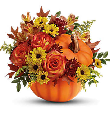 Autumn floral arrangement in a pumpkin container with roses and daisies