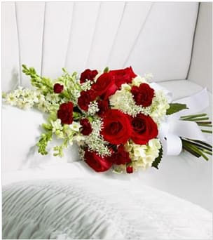 The FTD® Forever in Our Hearts™ Casket Adornment - The FTD® Forever in Our Hearts™ Casket Adornment is a beautiful accent piece that adds that extra touch of elegance to their final farewell service. Red roses and mini carnations are eye-catching and bright arranged amongst white hydrangea, larkspur, snapdragons and Queen Anne's Lace. Tied together with a white grosgrain ribbon, this gorgeous bouquet is a lovely way to say goodbye to your beloved. Approximately 20"L x 10"W. Your purchase includes a complimentary personalized gift message.