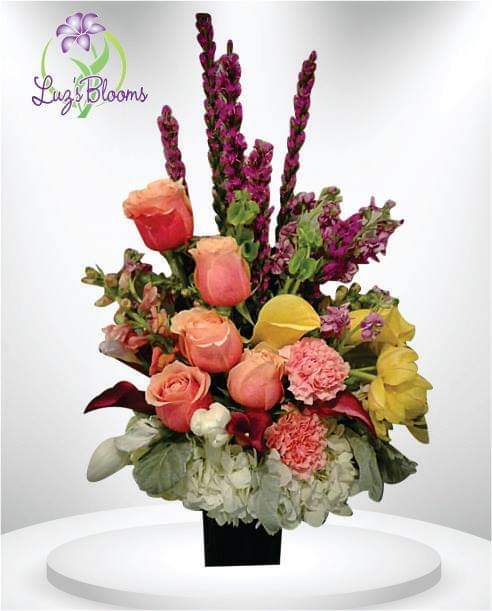 Pink Perfection - This soft display of pink carnations, alstromeria, and purple roses with a touch of white stock is a delicate way to send flowers for an illness, thank you, baby girl congratulations or just because.