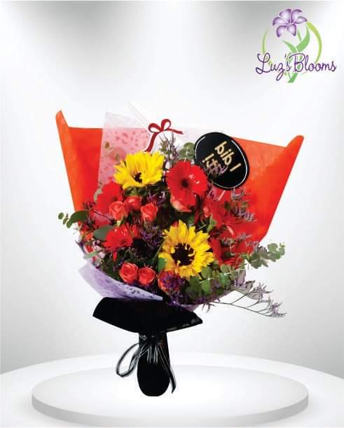 Bouquet of red and yellow flowers wrapped in orange paper