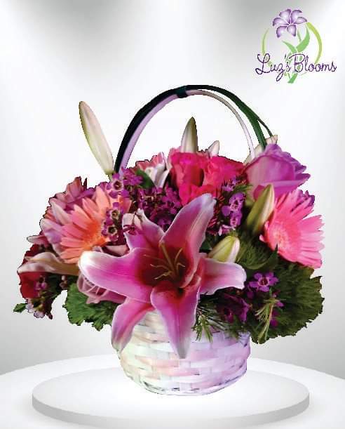Pink and purple mixed flower basket with lilies and daisies