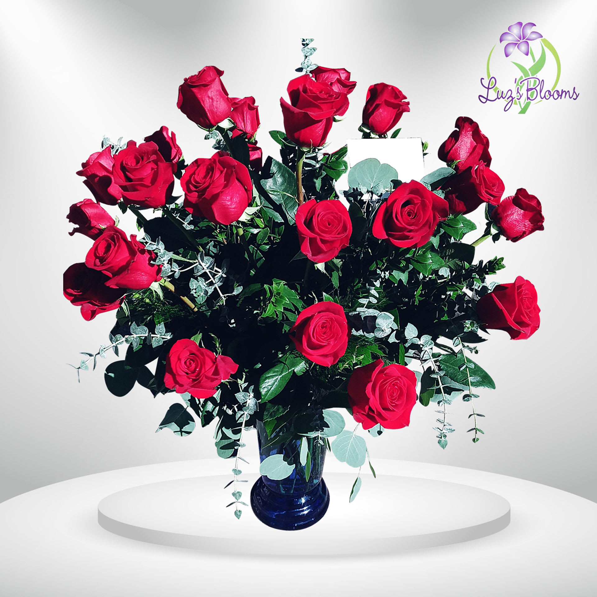 Bouquet of red roses in a blue glass vase