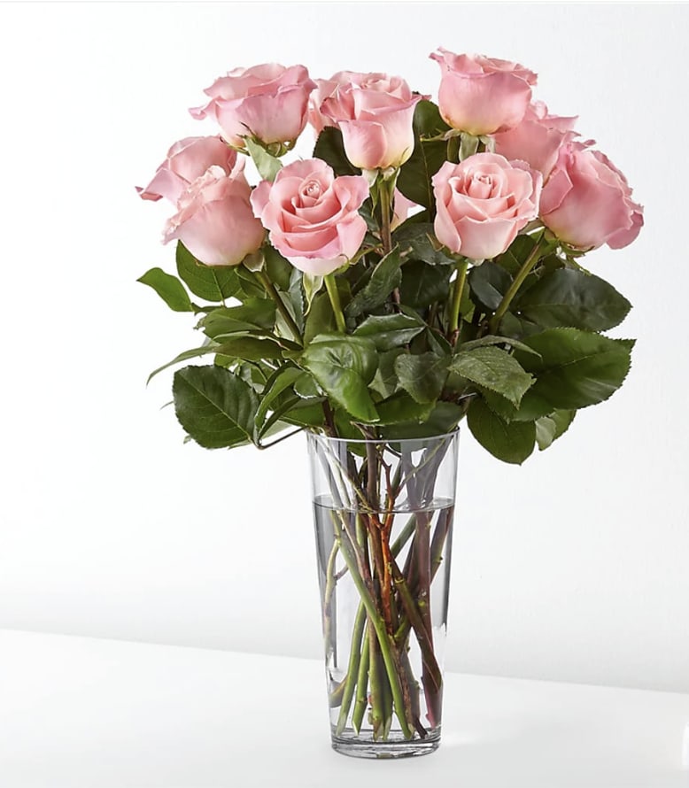 Pink roses arranged in a clear glass vase