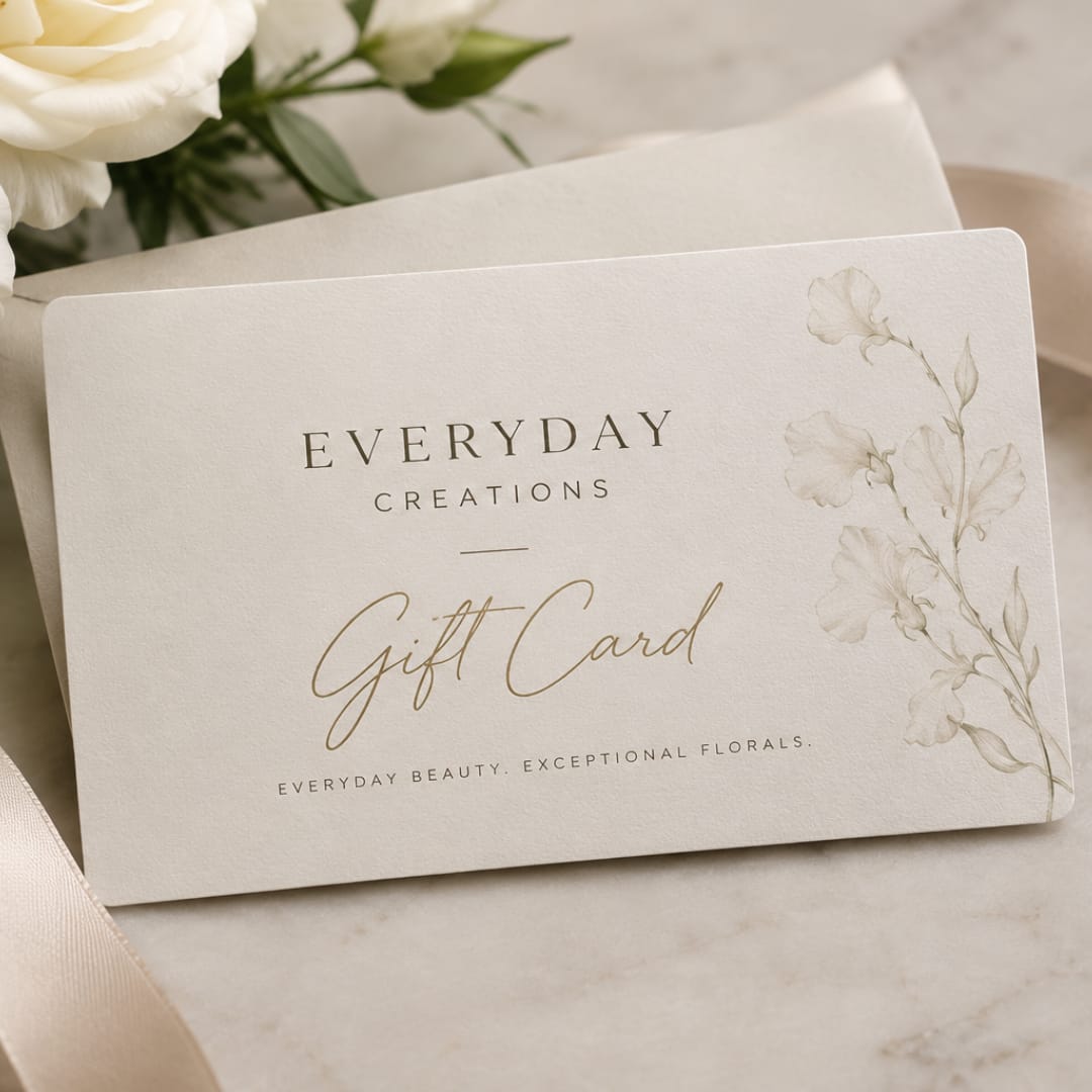 Floral gift card on a neutral surface with white flowers in the background
