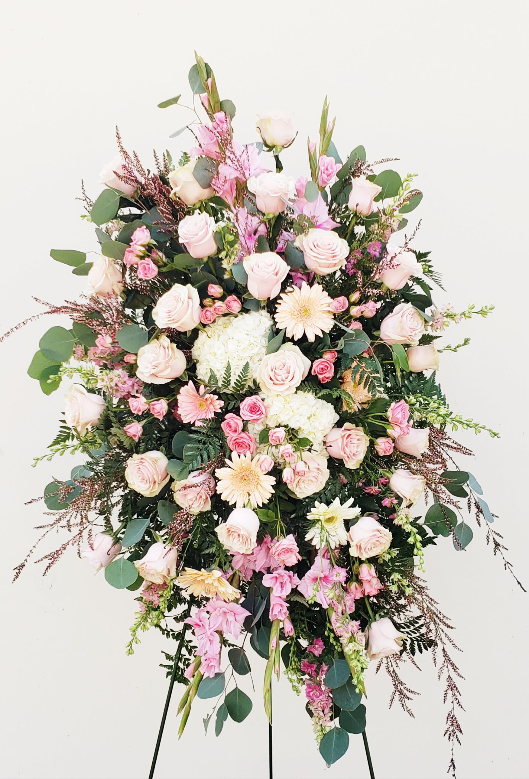 Standing floral spray with pale pink roses and gerbera daisies