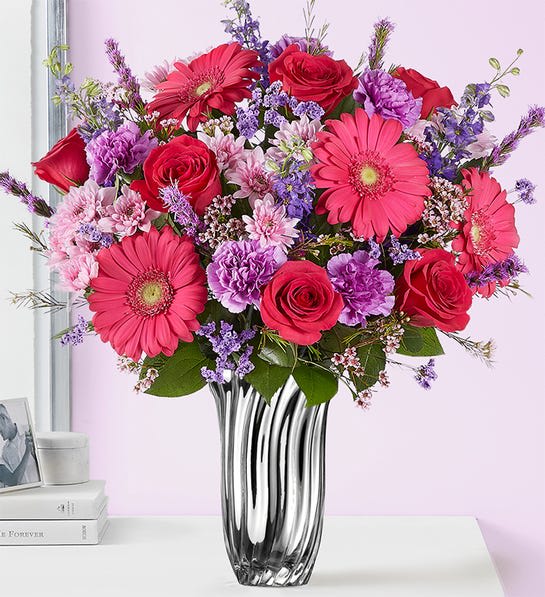 Bouquet of pink and red flowers in a clear glass vase