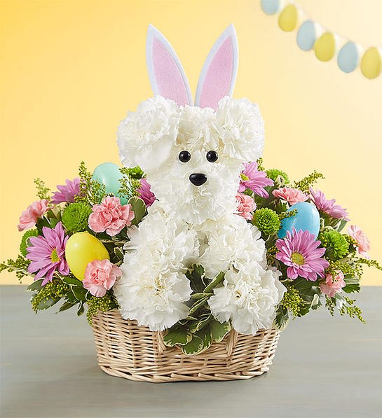 Basket arrangement with a white teddy bear and pastel flowers