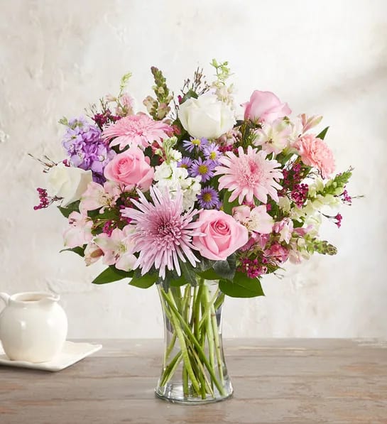 Pink and white mixed bouquet in a clear glass vase