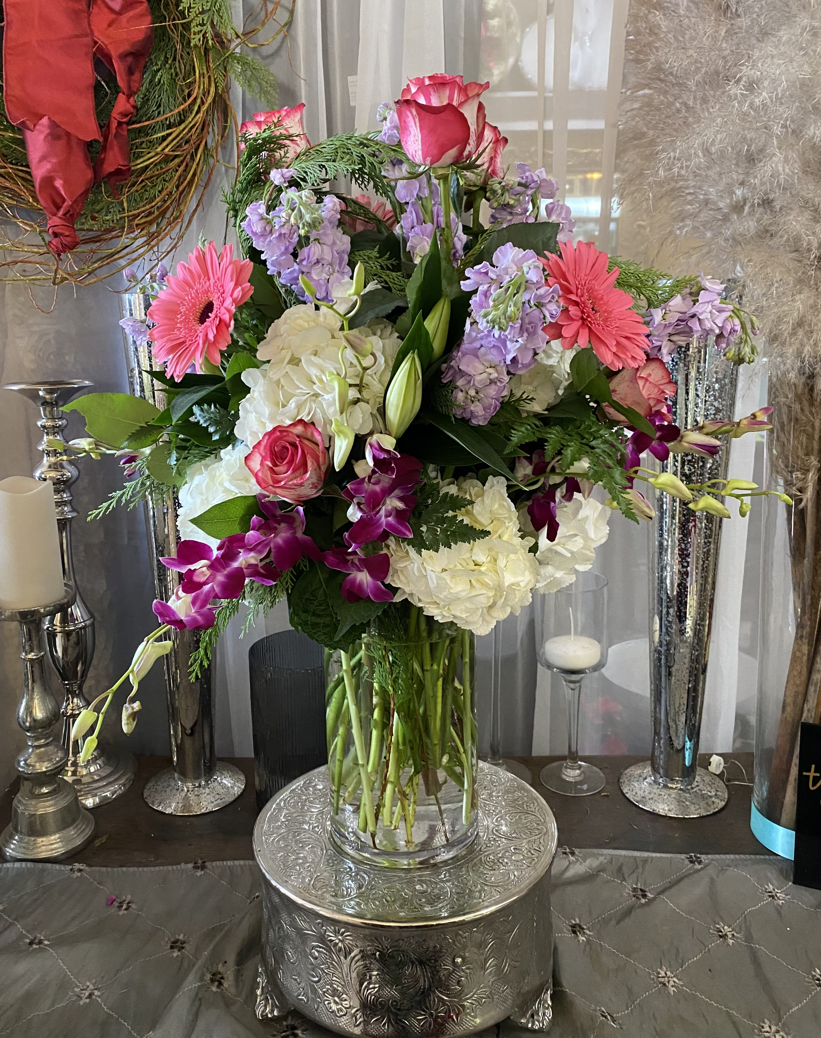 Mixed bouquet of pink, white, and purple flowers in a glass vase