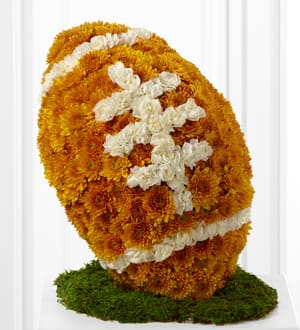 Orange and white chrysanthemum floral sculpture on a green base