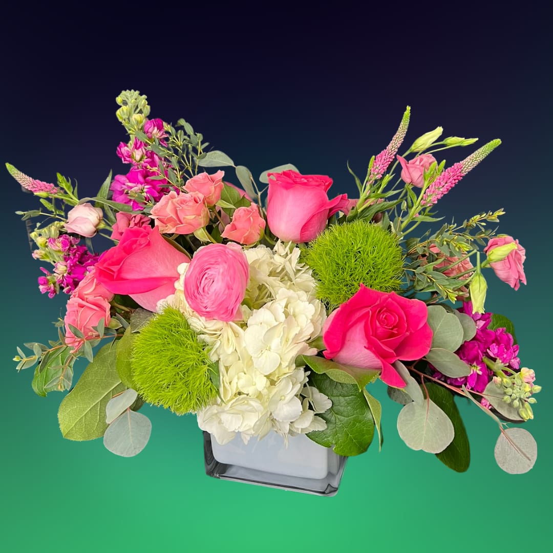 Pink roses and white hydrangea in a square glass vase