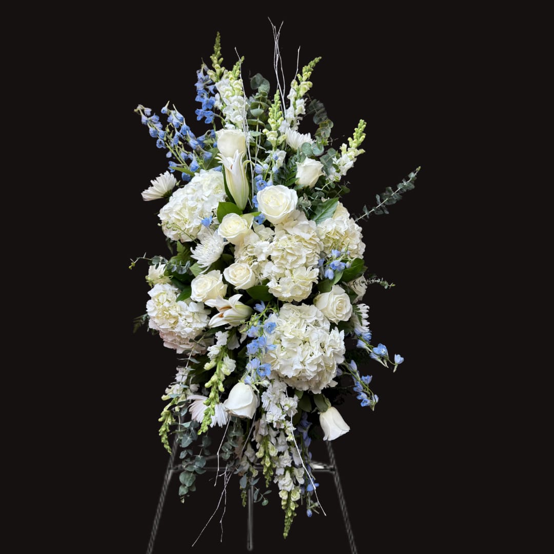 Tall white and blue floral spray on a stand