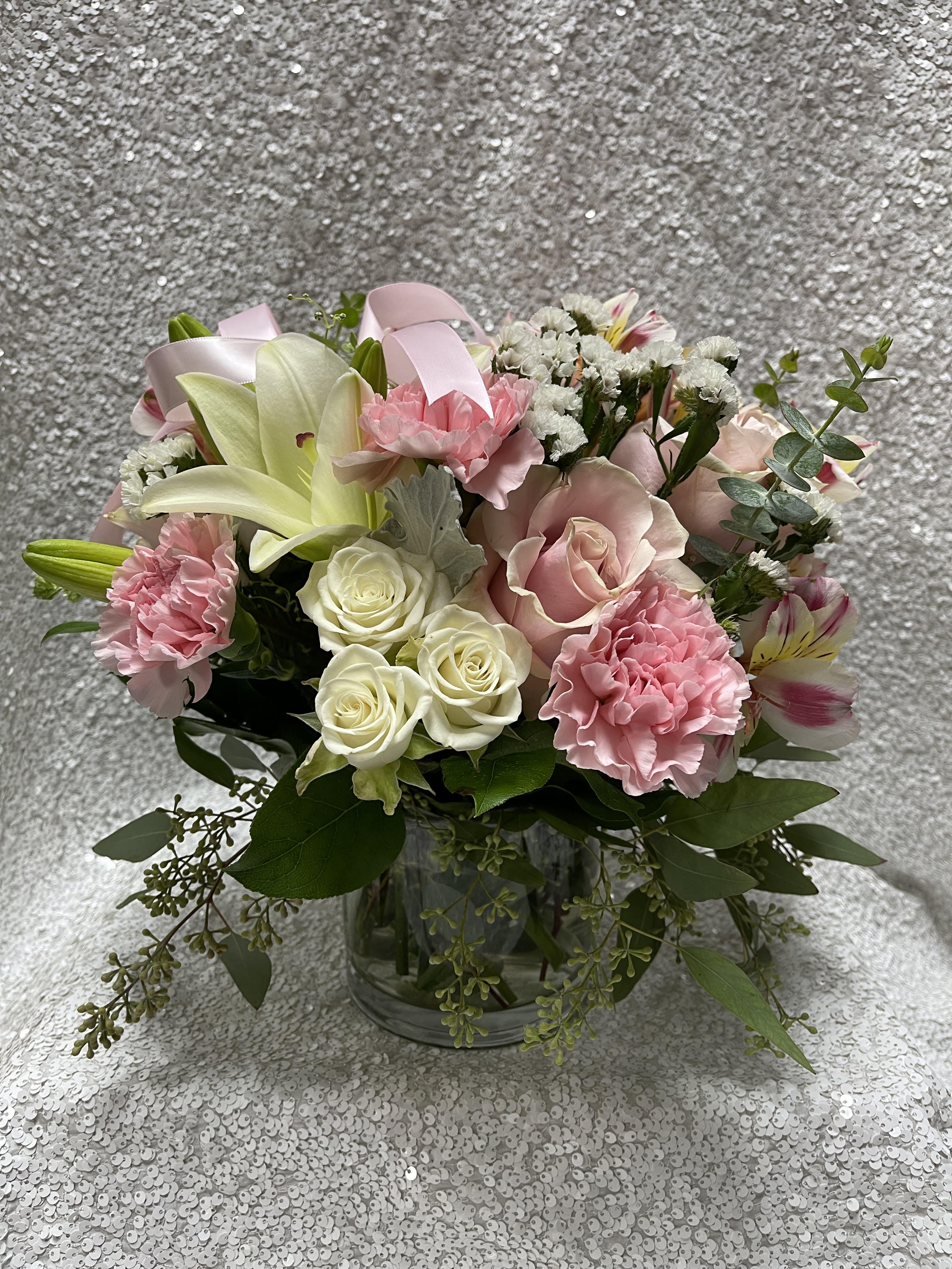Pink and white mixed flower bouquet in a clear glass vase