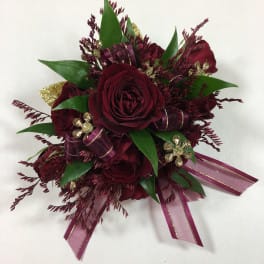 Dark red rose bouquet with green leaves and purple ribbon