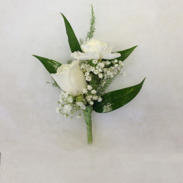 White rose boutonniere with baby's breath and green leaves
