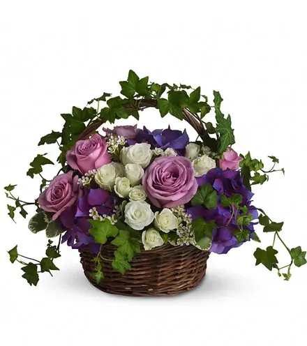 Basket of pink, white, and purple roses with ivy