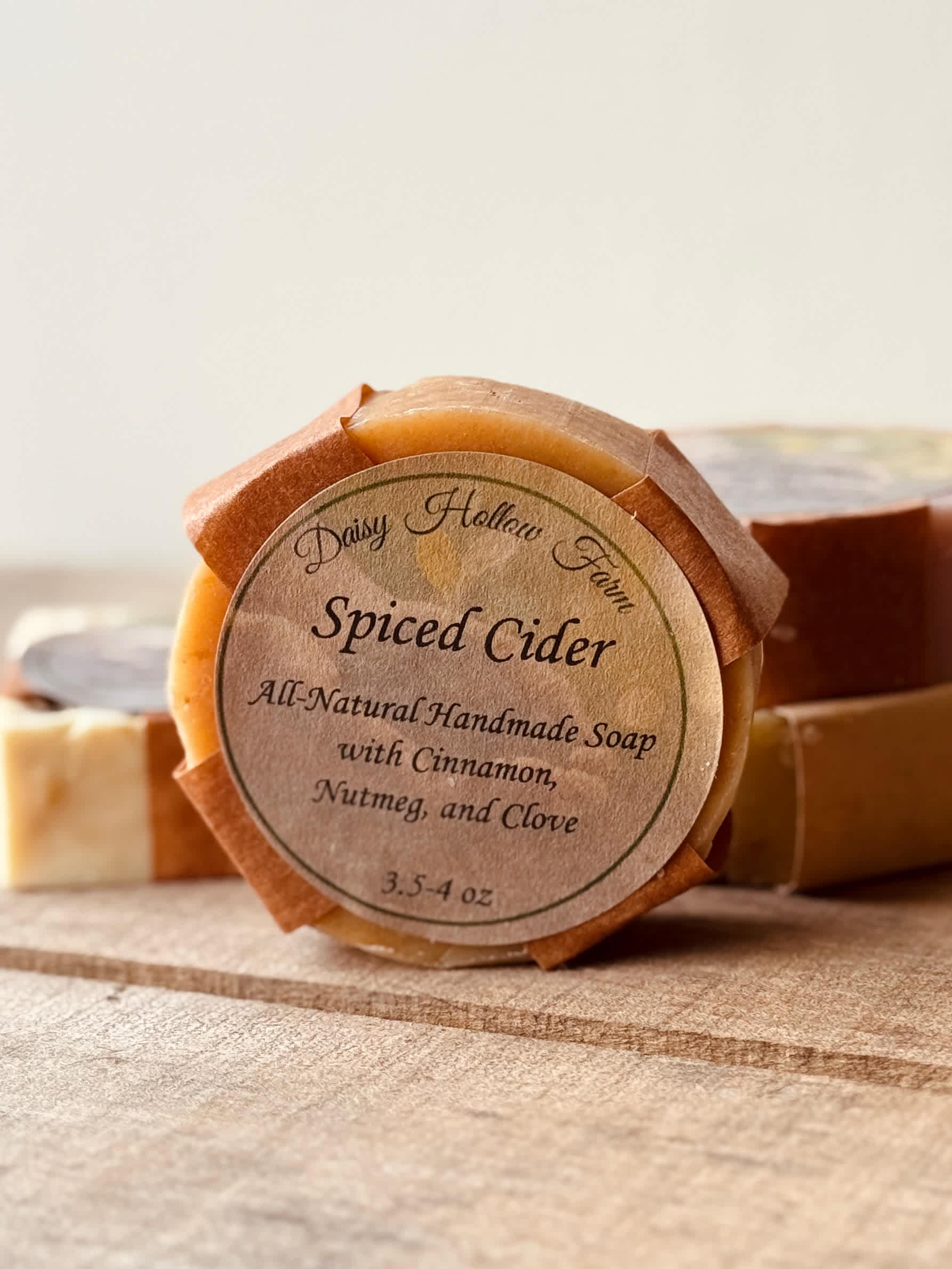 Round spiced cider soap bars wrapped in brown paper labels