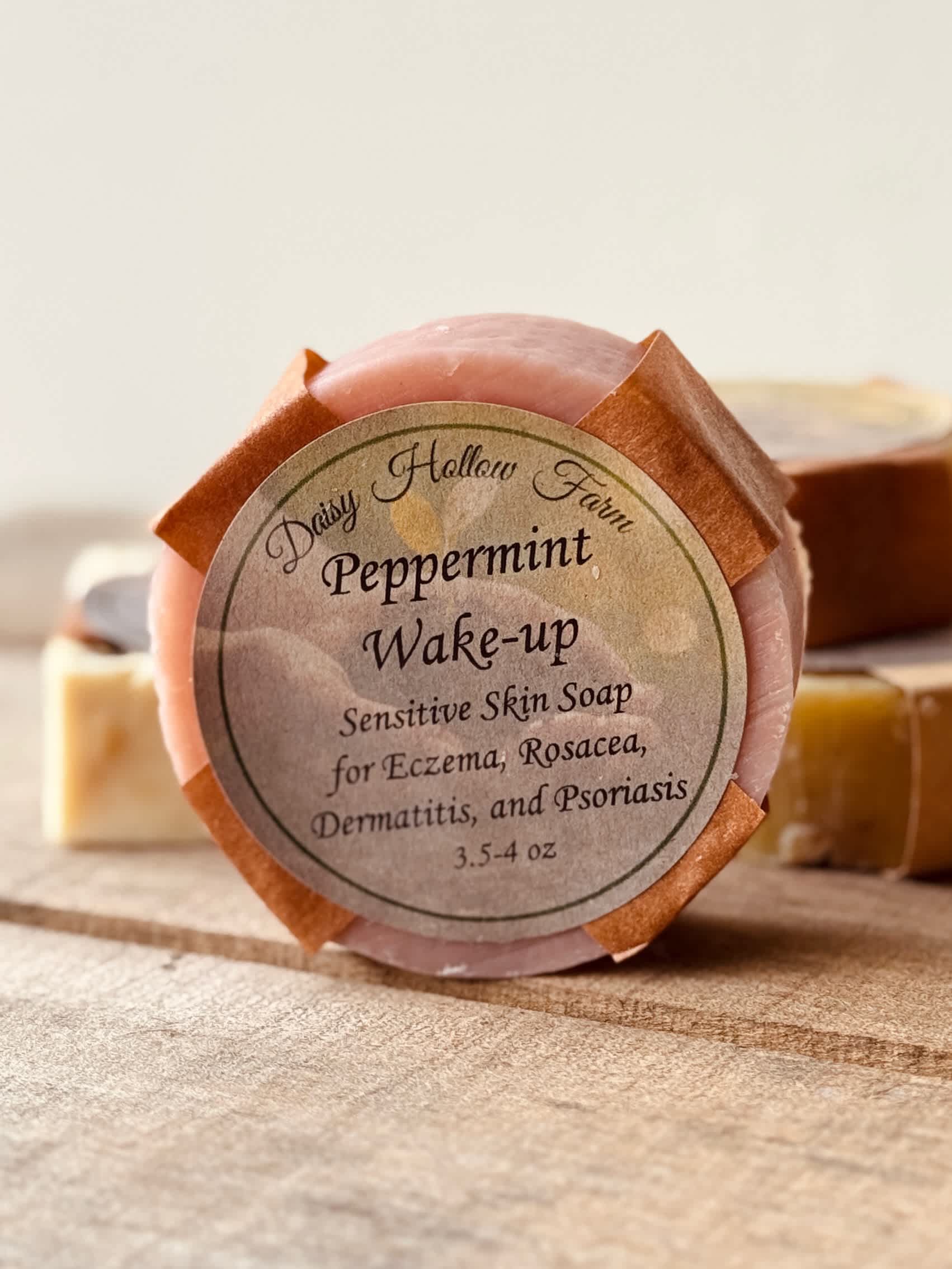 Round peppermint soap bar with a labeled paper wrap