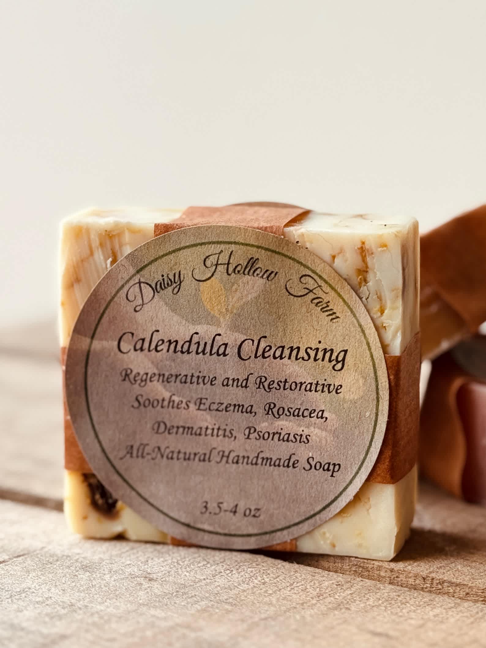 Handmade calendula cleansing soap bar with a round label