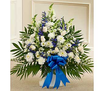 Large white and blue floral spray with a blue ribbon