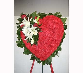 Bleeding Heart - This heart shaped spray is filled with rich Roses, Lilies, and Carnations.      As Shown : HF114 