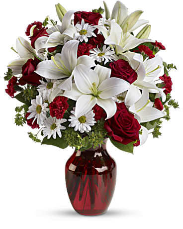 Be My Love - Add some romance with this rich arrangement of luxurious flowers in classic winter colors gathered in a ruby red vase she'll use for any occasion! Stems: Red roses, white asiatic lilies, white daisy spray chrysanthemums, mini red carnations and sprigs of bupleurum and salal Vase: Red Glass Vase 