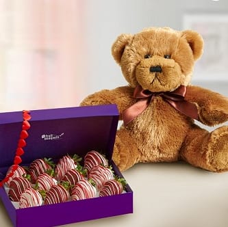 Lots of Love - Product ID: 102889  Satisfy her sweet toothâand her love of all things cute &amp; cuddlyâwith the perfect âI love youâ gift. A box of decadent strawberries, dipped and drizzled in chocolaty confections, is paired up with a soft plush bear for her to snuggle up with (but only when youâre not there!) The box includes 6-12 large strawberries dipped in milk and white chocolate and topped with red and pink drizzle. All of our dipped fruit is covered in delicious milk and white chocolaty confection and red and pink chocolaty confections, a plush bear with bow (Allergy Warning: Fruit Bouquets products may contain peanuts and/or tree nuts. We recommend that you take the necessary precautions based on any related allergies as we cannot guarantee against cross-contamination.) 7 day notice is required prior to delivery date, as dipped strawberries are not always available in our area.