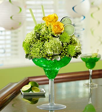 Margarita Bouquet - Product ID: 102028  EXCLUSIVE Toast that special occasion in style -- send our truly original lime margarita arrangement. Mixed with yellow roses, green carnations, green spider mums, poms and hypericum, this fresh floral cocktail is hand-arranged in an oversized acrylic margarita glass. Accented with realistic green lime slices and green straws, it's an unforgettable gift that will keep the party going. Stylish arrangement of roses, carnations, poms, spider mums, hypericum and variegated pittosporum Hand-designed by our florists in a 10"H oversized acrylic margarita glass Accented with straws and green lime slice picks Extra Large arrangement measures approximately 15"H x 9"L Large arrangement measures approximately 14"H x 8.5"L Medium arrangement does not include hypericum and measures approximately 13"H x 8"L Small arrangement does not include hypericum or carnations and measures approximately 12.5"H x 7"L Our florists select the freshest flowers available so colors and varieties may vary