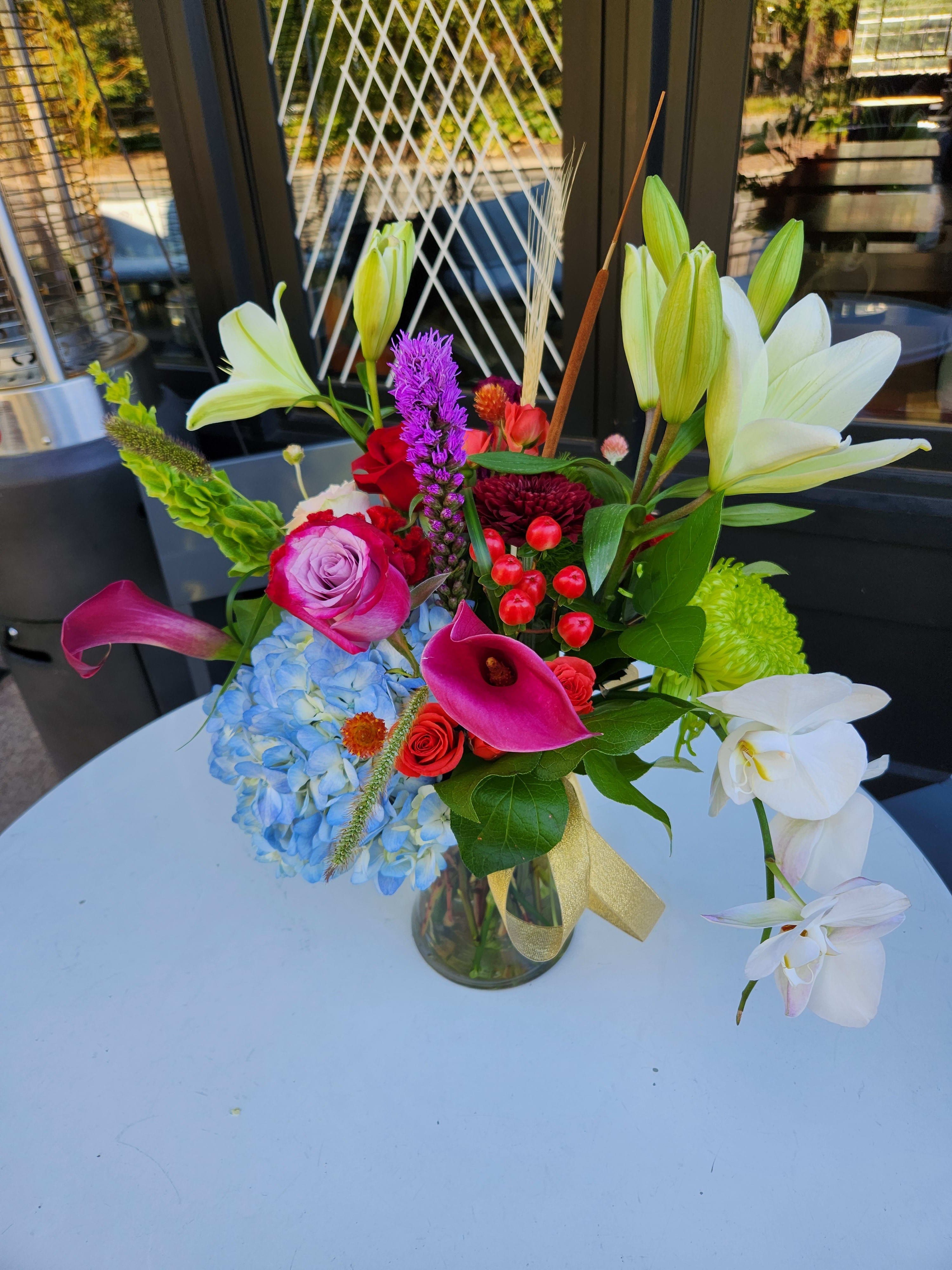 Designers Choice Bright and Contemporary - A mixed bouquet of bright and colorful blooms and textures in a contemporary design.