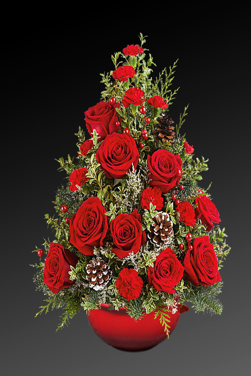 Red roses and carnations arranged in a red bowl with pinecones