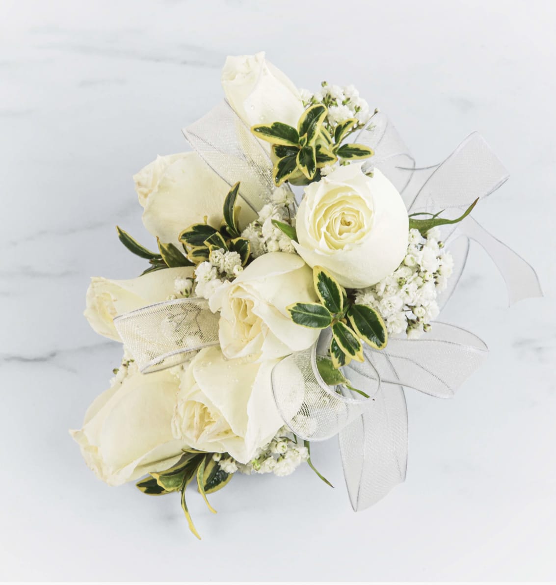 White Rose Corsage by BloomNation™  - A classic white corsage with silver sheer ribbon, this wrist arrangement looks good with any outfit. A perfect compliment to any prom, formal, or wedding event. 