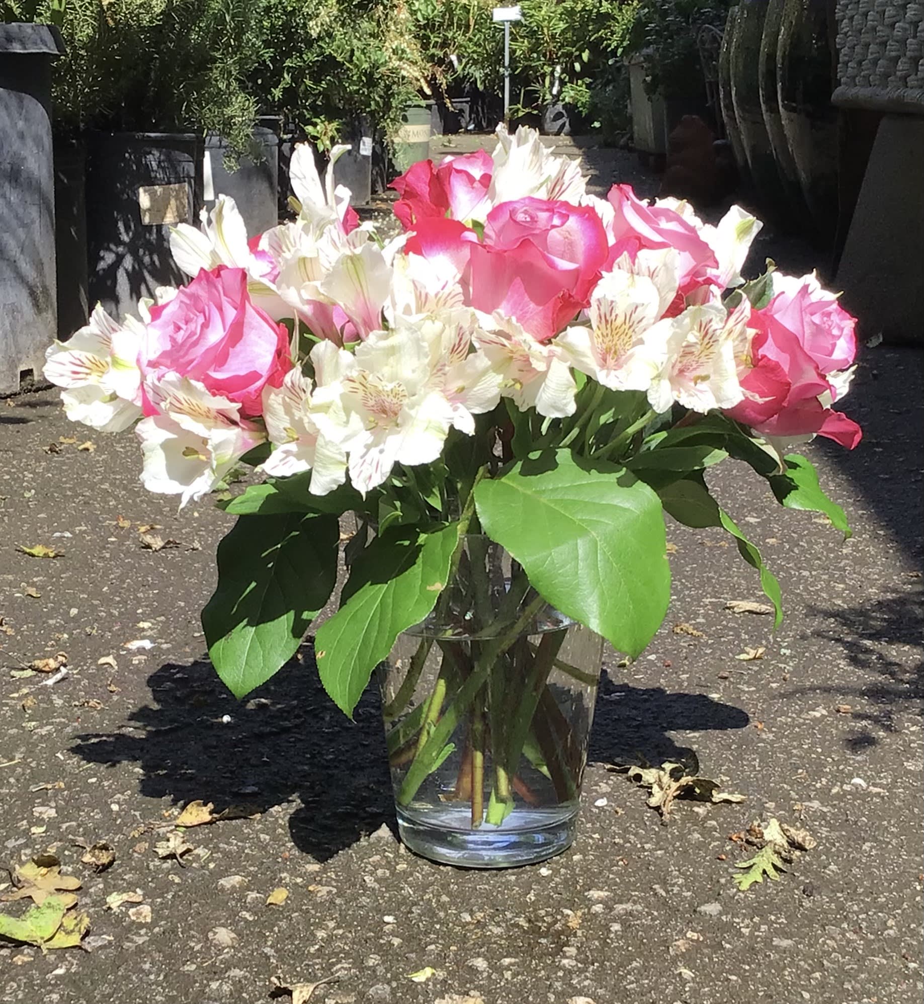 Pink roses and white alstroemeria in a clear glass vase