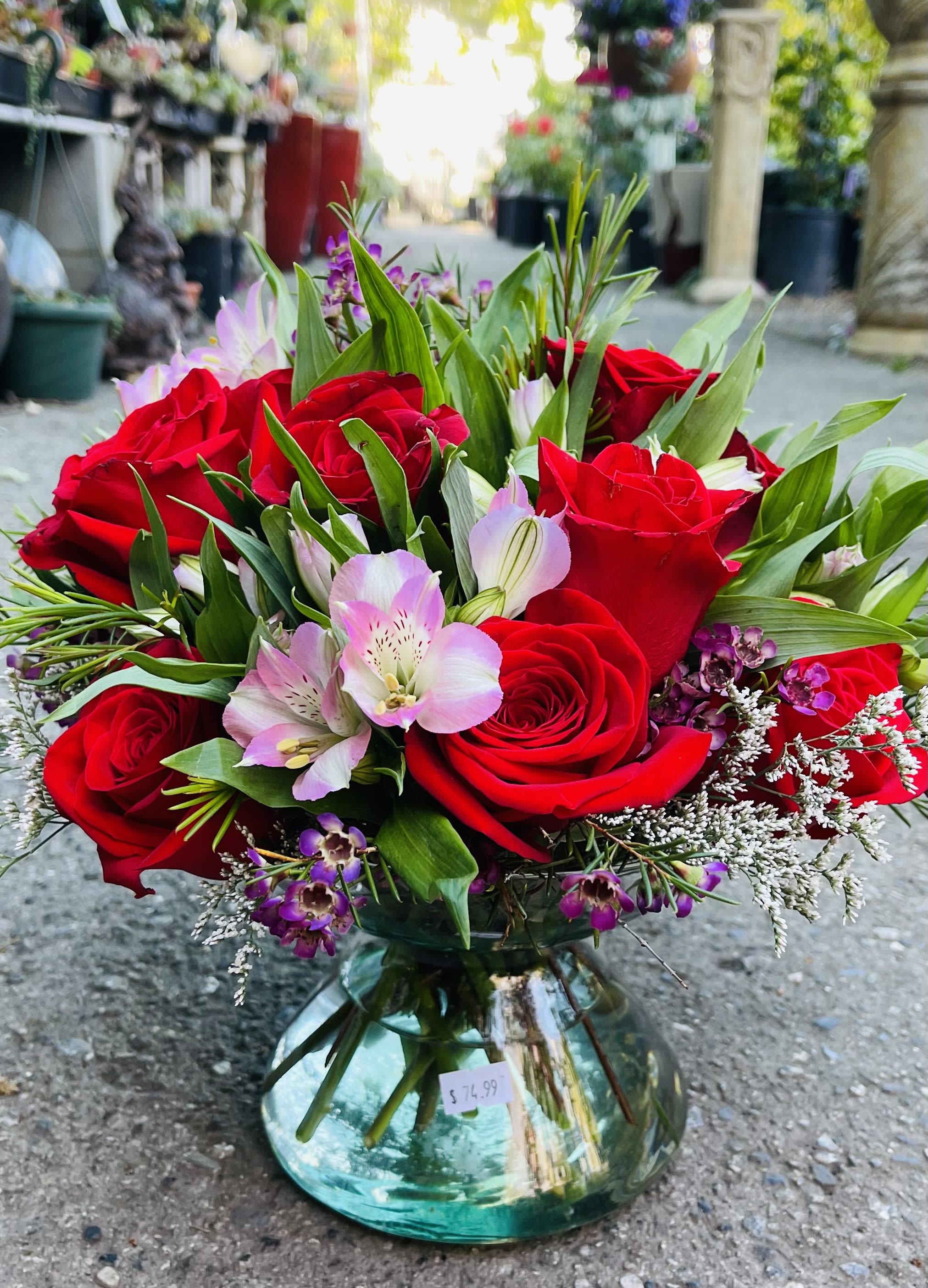 Red roses and pink alstroemeria in a glass vase