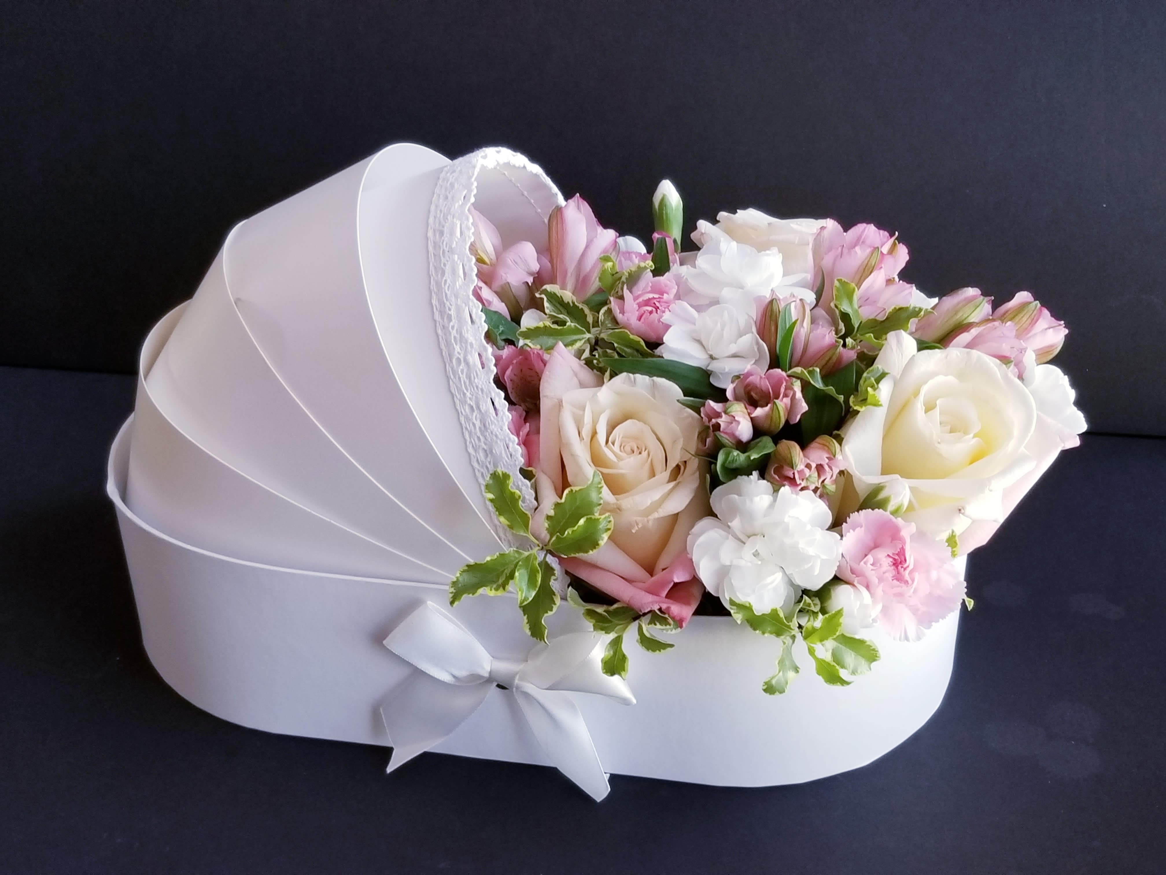 Pink and white bouquet in a white heart-shaped box