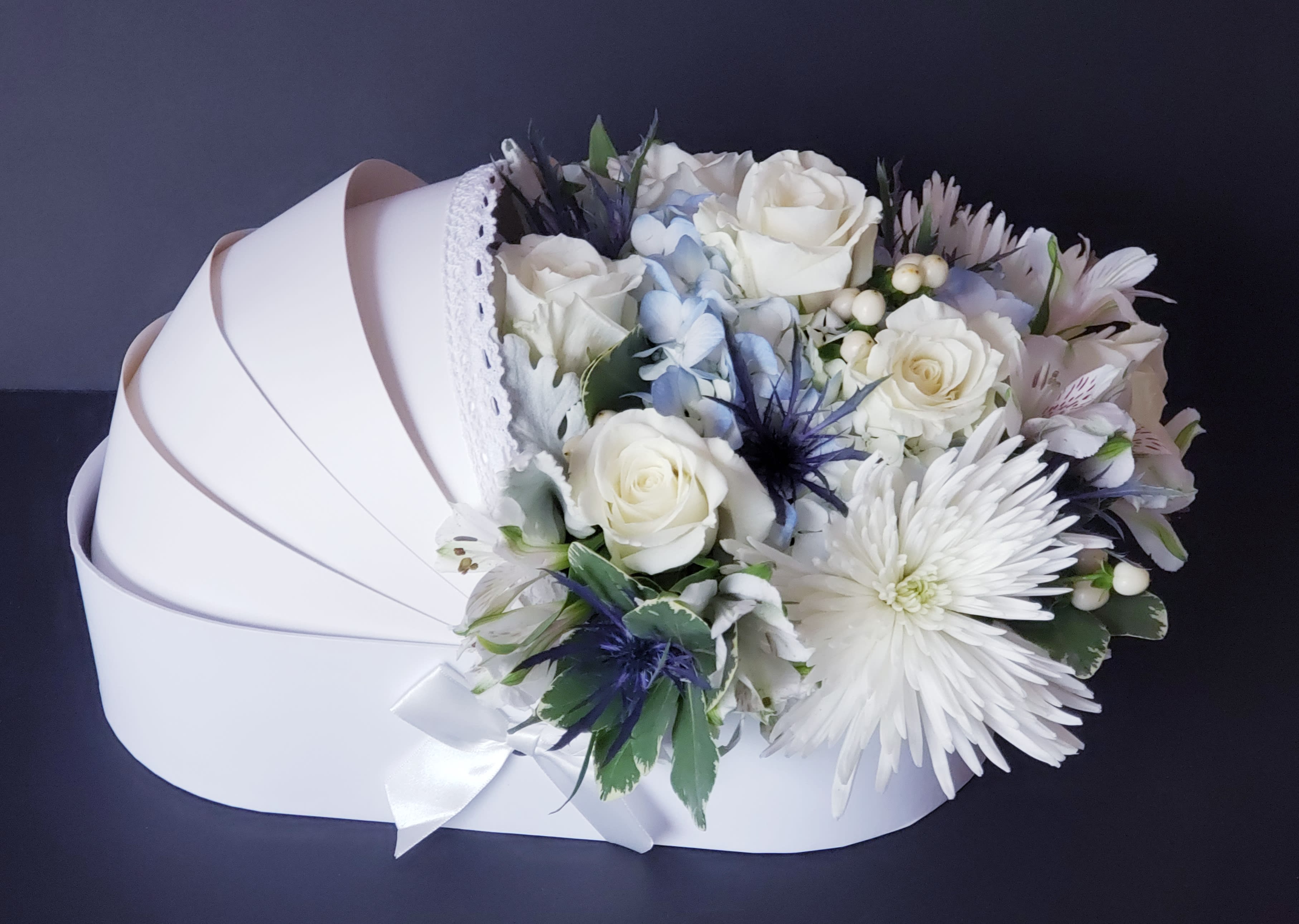 White rose bouquet with pale blue accents in a white box