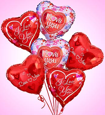 Cluster of heart-shaped red and floral balloons with love messages