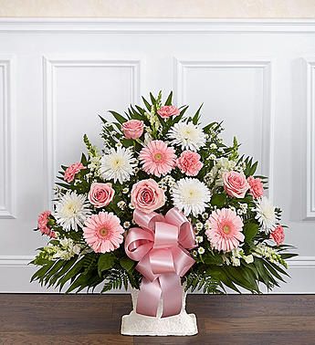 Tribute Pink &amp; White Floor Basket Arrangement - Product ID: 91207   When words arenât enough to convey all you feel at this difficult time, let our beautiful floor basket arrangement help you express your feelings perfectly. With pink flowers to symbolize admiration and appreciation for a life well lived and white flowers to symbolize peace and respect, this gathering of fresh roses, snapdragons, carnations and more brings beauty and hope to a difficult time. Floor basket arrangement of fresh pink roses, white spider mums, white snapdragons, pink carnations and more Appropriate for family, friends or business associates to send directly to the funeral home Our florists use only the freshest flowers available, so colors and varieties may vary Large arrangement measures approximately 32"H x 40"L Medium arrangement measures approximately 32"H x 38"L Small arrangement measures approximately 32"H x 32"L