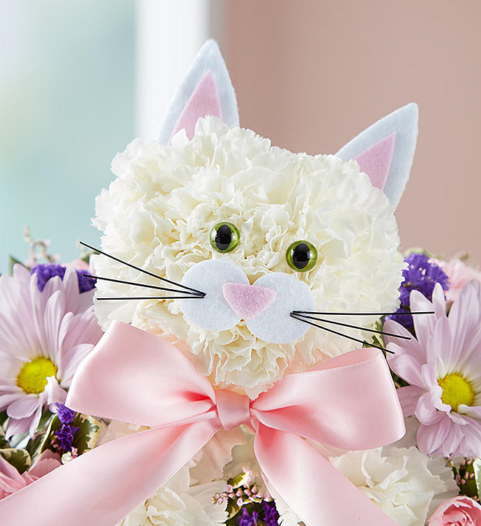 White floral cat face with pink ears and bow, surrounded by daisies